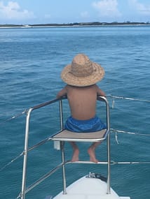The Bergeron's son at the bow of their catamaran charter in the Bahamas.