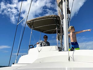 Brian and son skippering their bareboat catamaran in the Bahamas