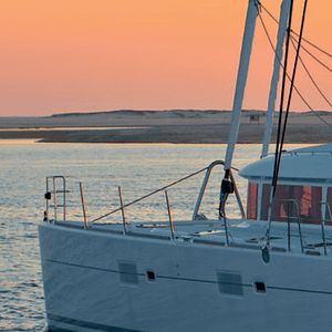 Lagoon 620 all-inclusive yacht charter in a caribbean sunset